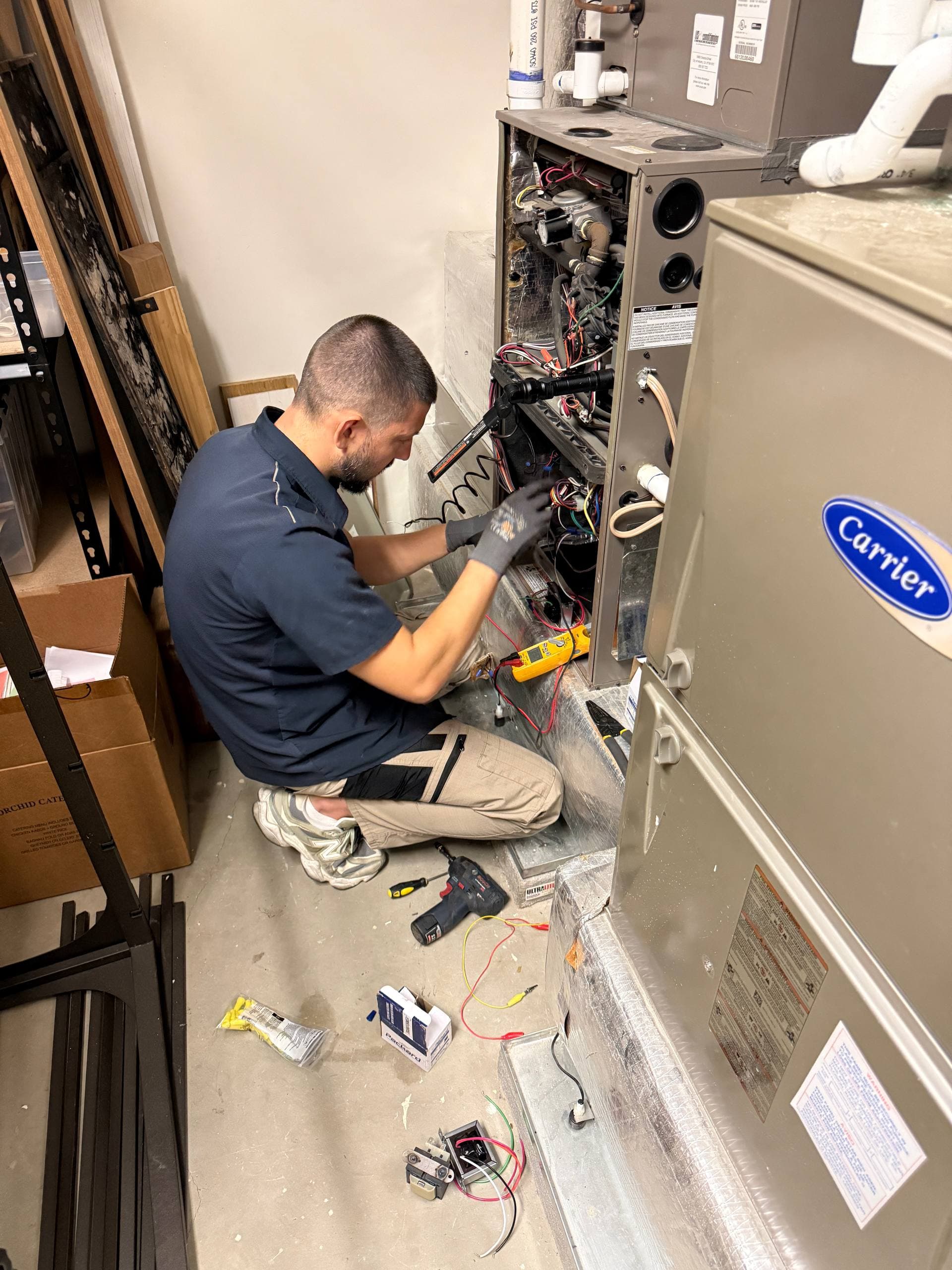 Technician installing a Carrier HVAC system