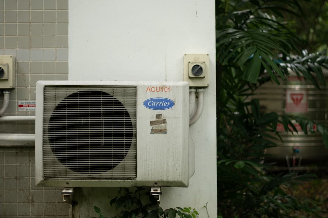 Carrier air conditioning outdoor unit being serviced by a technician in a Chicago suburban backyard